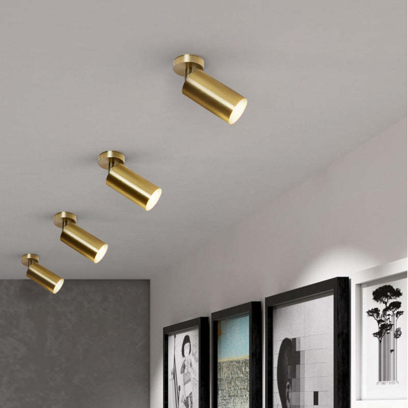 Gold cylinder Freja flush mount ceiling light in home.