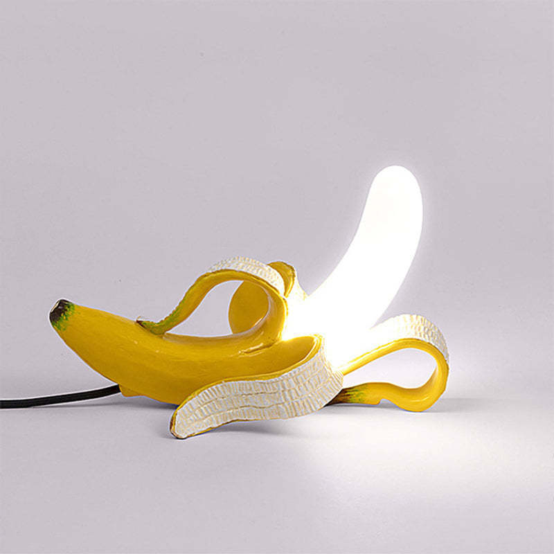 Banana-shaped table lamp with a glowing light