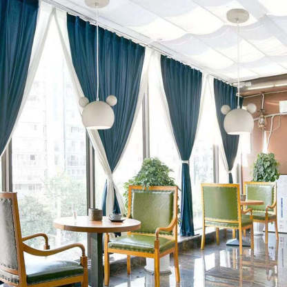 Las Sola: Cartoon pendant lights in a stylish room setting.