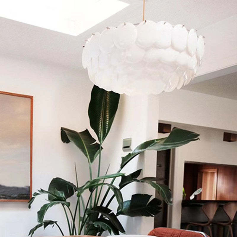 White ceramic leaf chandelier in living room, art deco lighting.