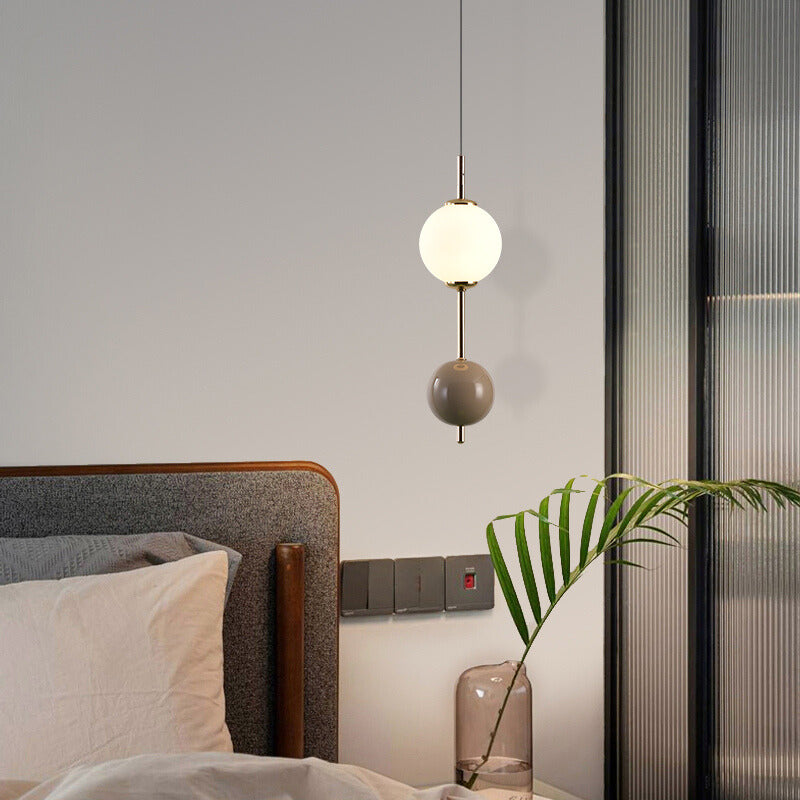 Modern sphere pendant light over bedroom bed