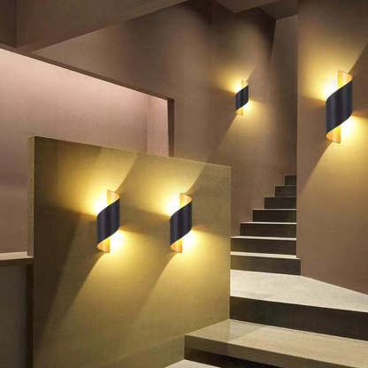 Modern conch wall lamps illuminate stairway. Las Sola lighting.