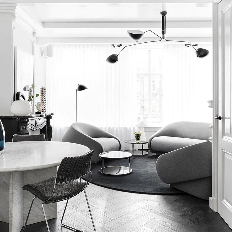 Modern living room with Schmitt pendant light, gray sofas, and marble table