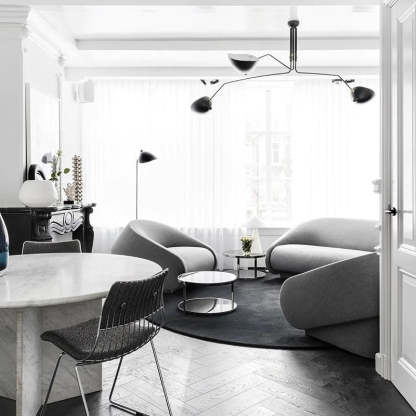 Modern living room with Schmitt pendant light, gray sofas, and marble table