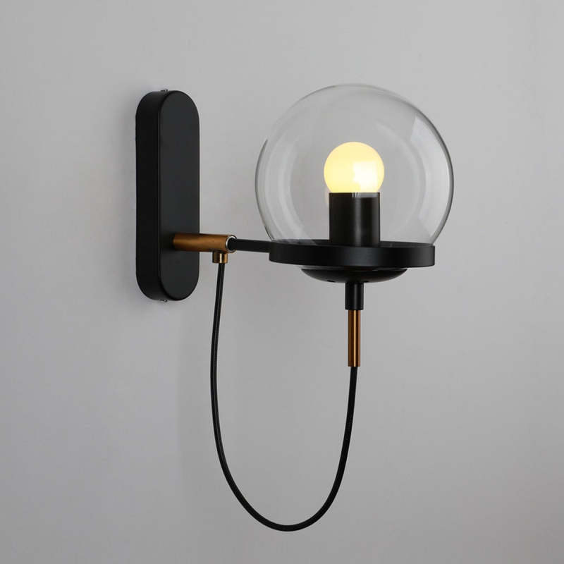Alessio wall lamp with glass globe, bronze and black finish.