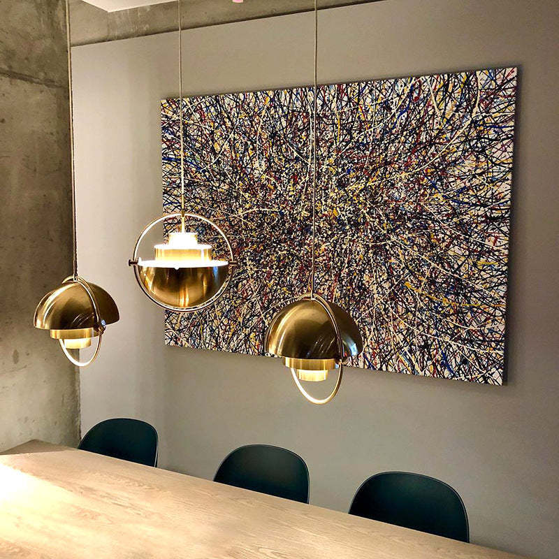 Modern gold pendant lights over dining table, interior design