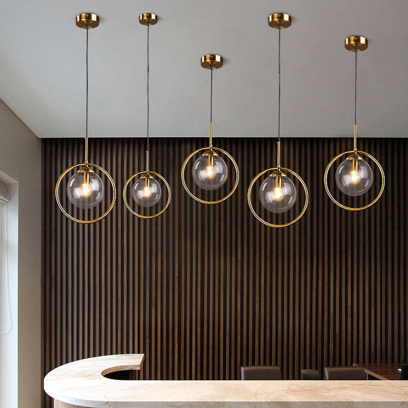 Hailie glass pendant lights. Gold ring modern lighting.