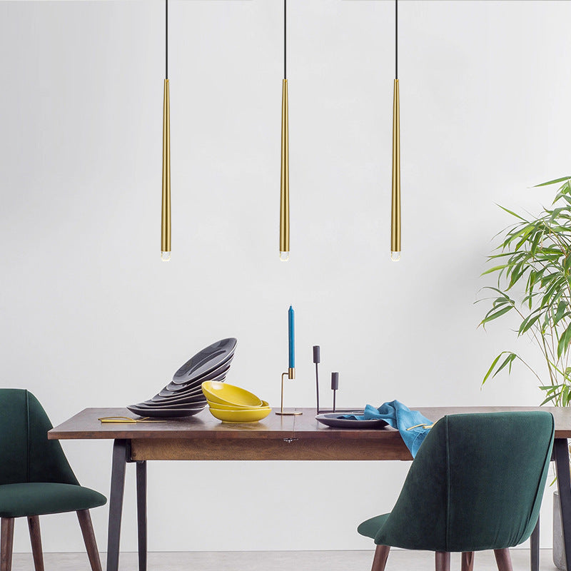 Carr gold pendant light over dining table