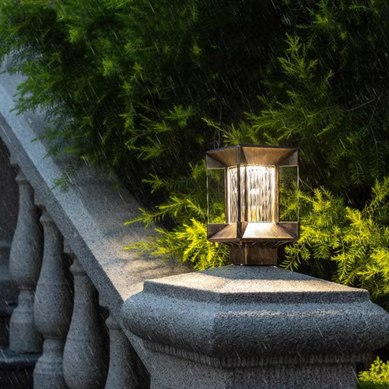 Riley Modern Outdoor Post Light illuminating a garden in the rain