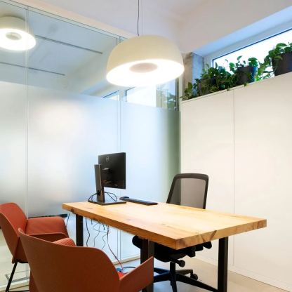 Modern office with Carins pendant light, wooden desk and orange chairs