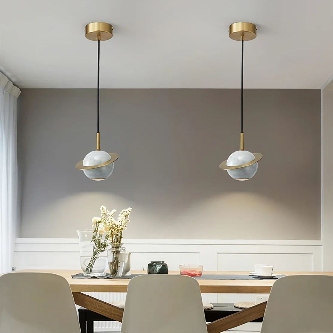 Modern marble pendant lights above dining table