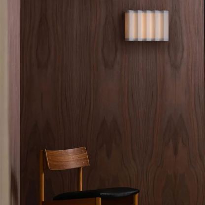 Renee Wall Lamp, chair and wood paneling. Ideal for bedroom lighting