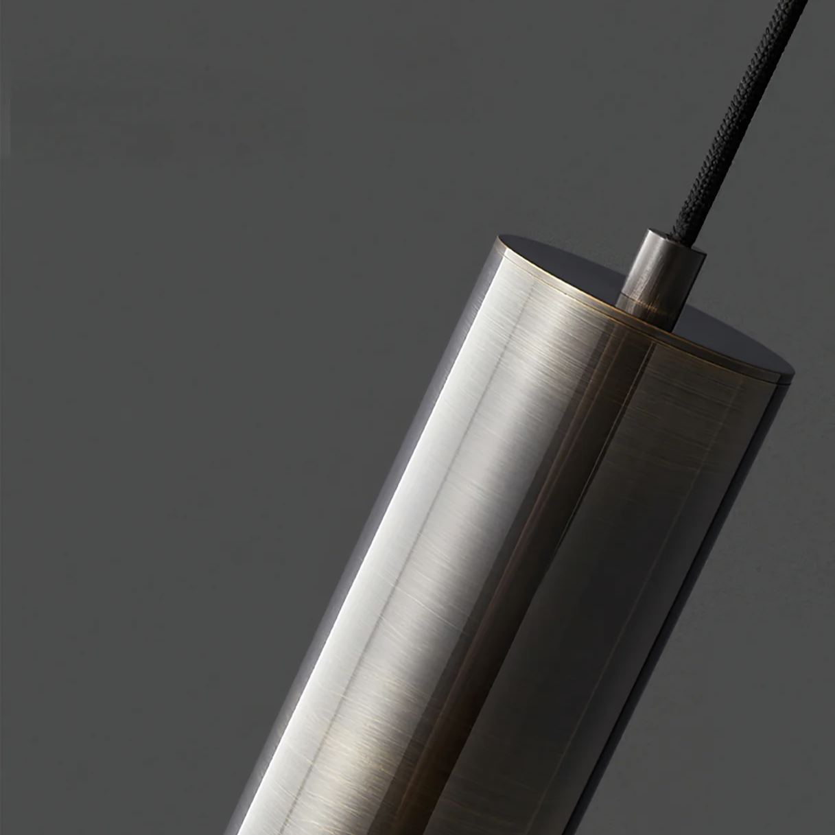 Close-up of Meza cylinder pendant light detail, metal finish