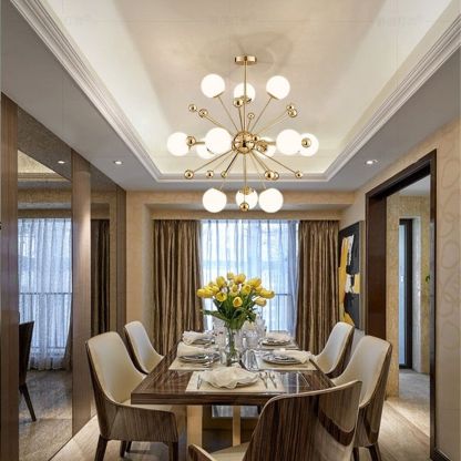 Golden chandelier over dining table with flowers