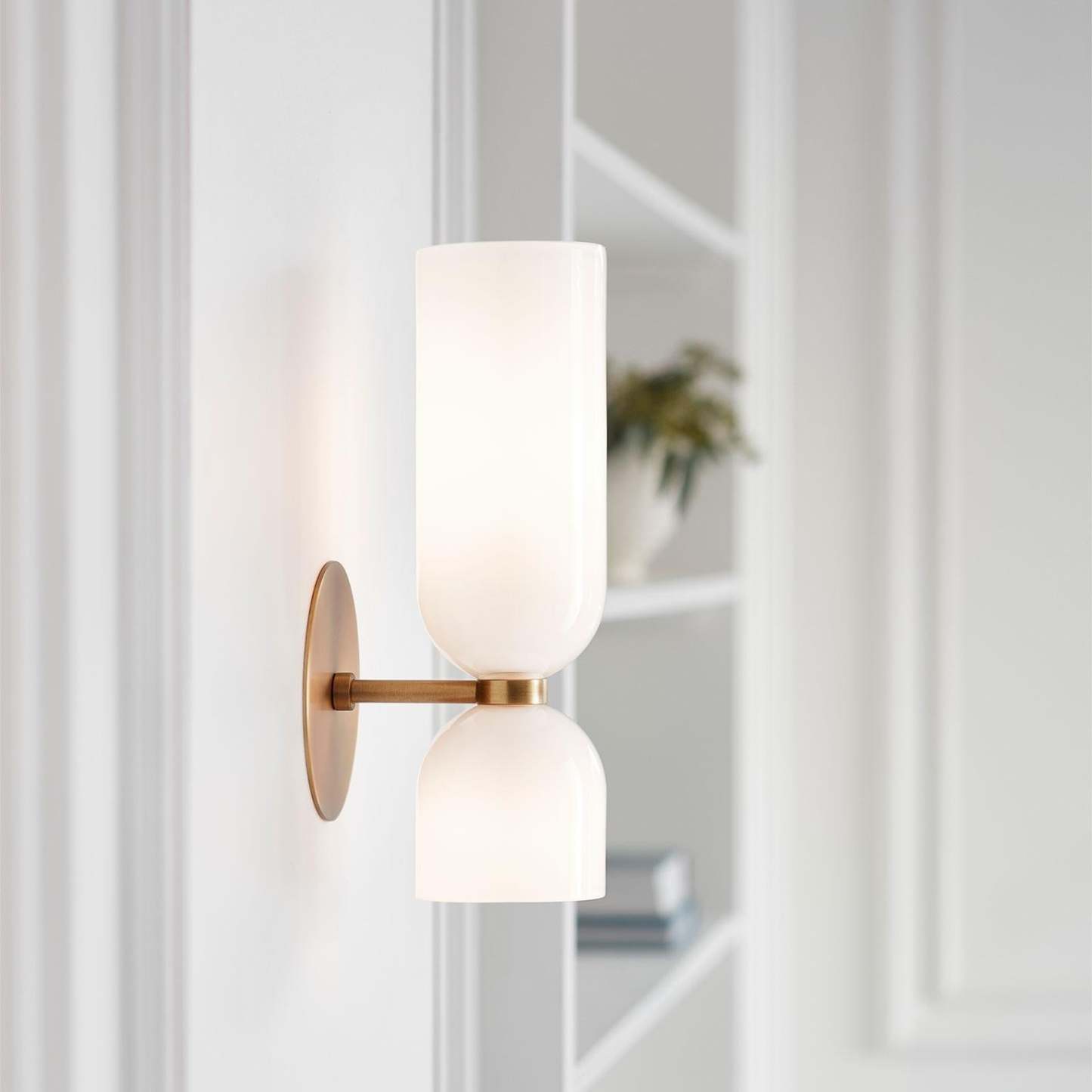 Modern Hailie glass wall sconce in bedroom setting