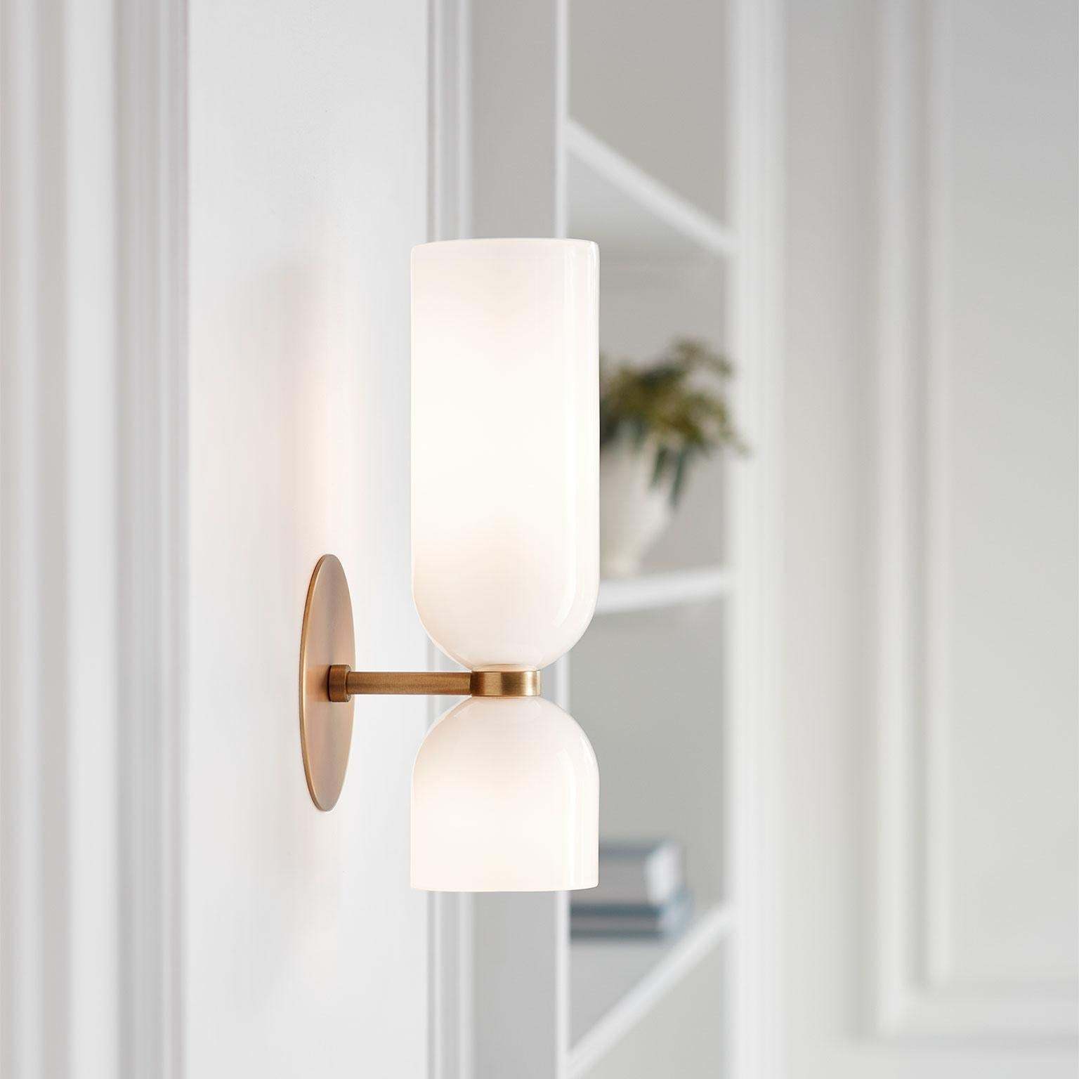Modern Hailie glass wall sconce in bedroom setting