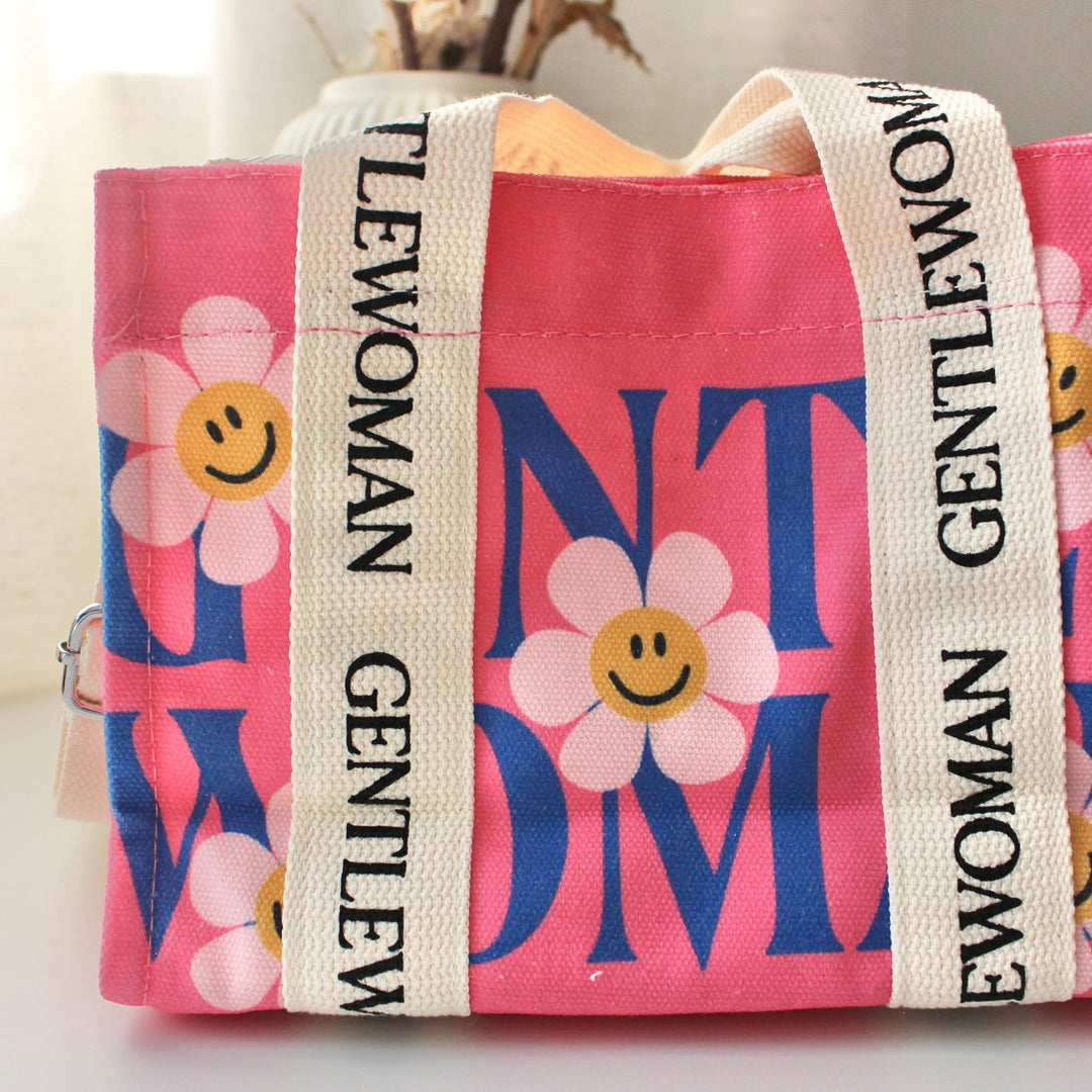 Compact pink canvas purse with crossbody functionality