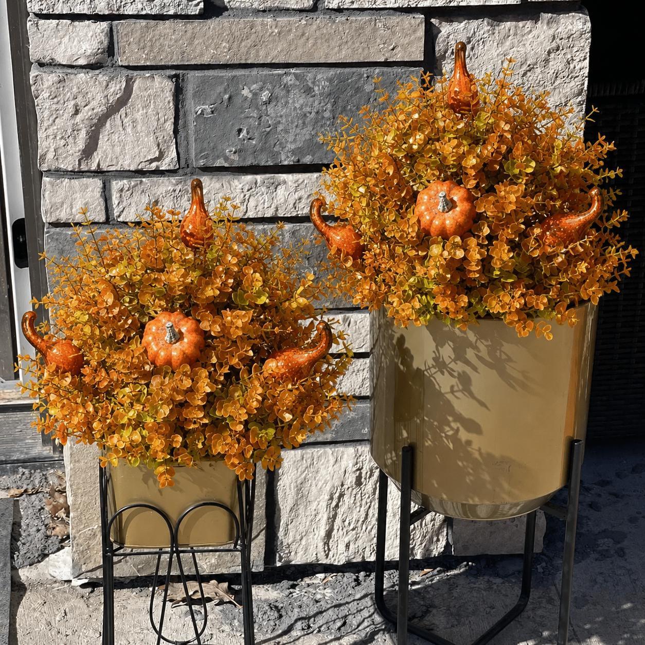 Two harvest garden stakes displayed on both sides of a front door