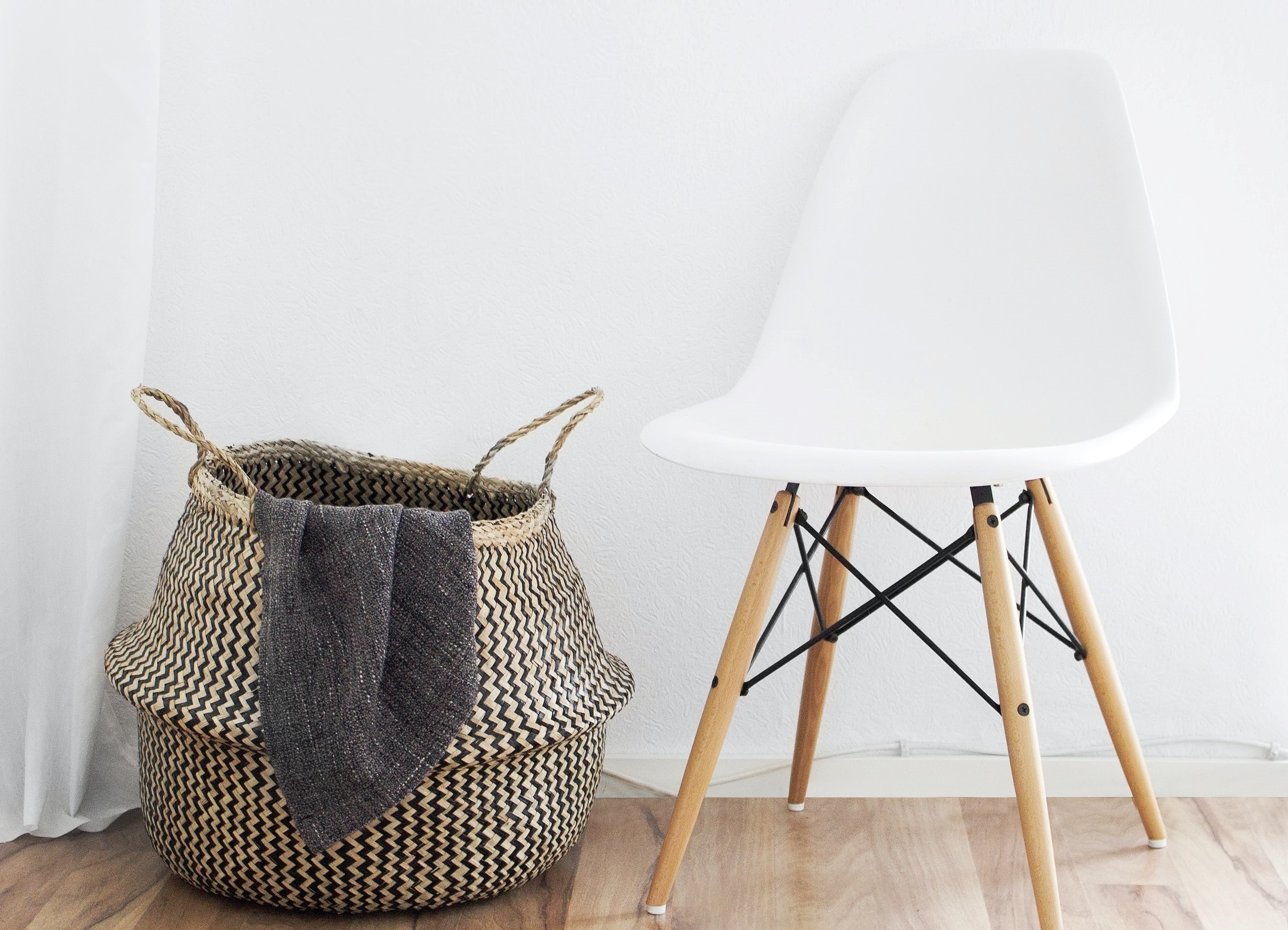 Laundry basket next to white chair