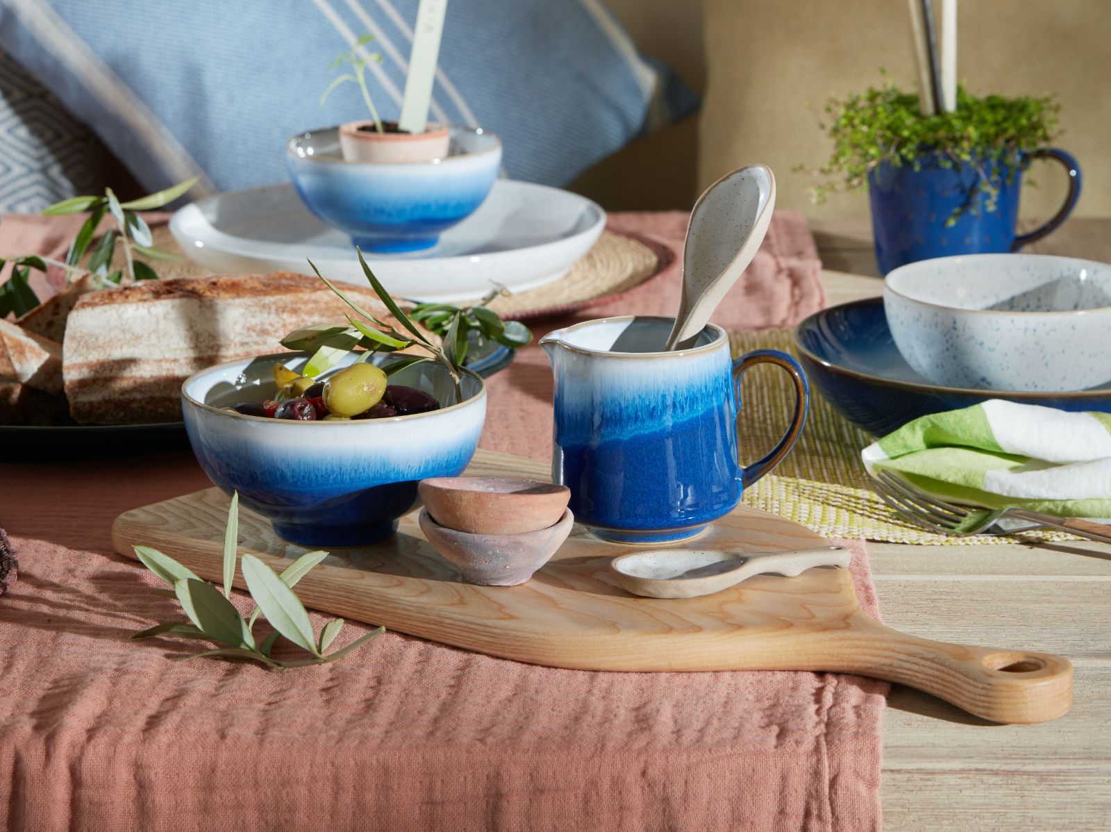 Bowl of olives on a wooden platter