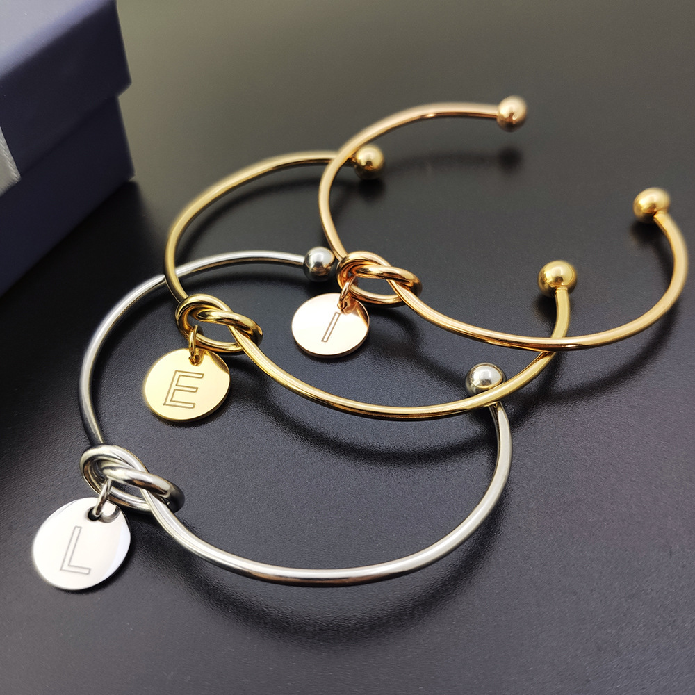 Alphabet charm tie bracelet
