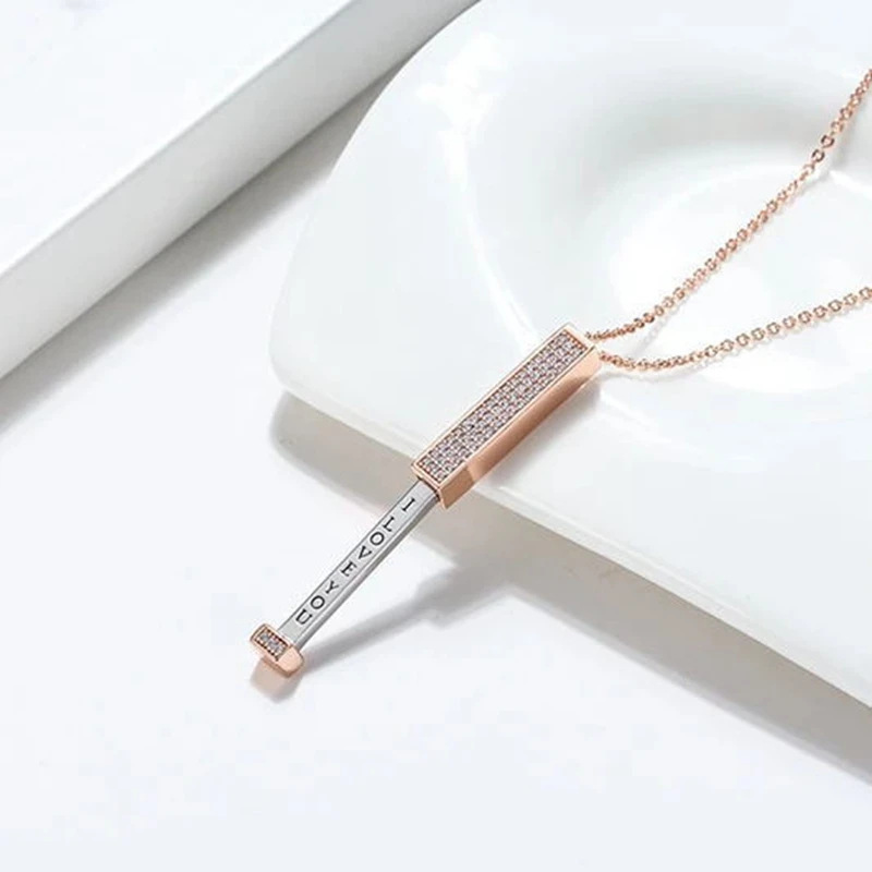 Zircon tube pendant with hidden engraved text