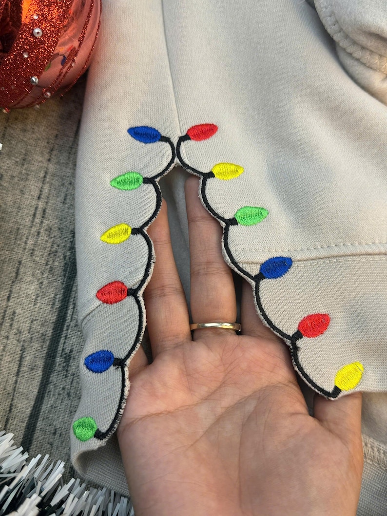 We Can Leave The Christmas Lights Up 'Til January sweatshirt , Embroidered Christmas Lights Cut Hem sweatshirt, Side Bow Appliqué Sweatshirt