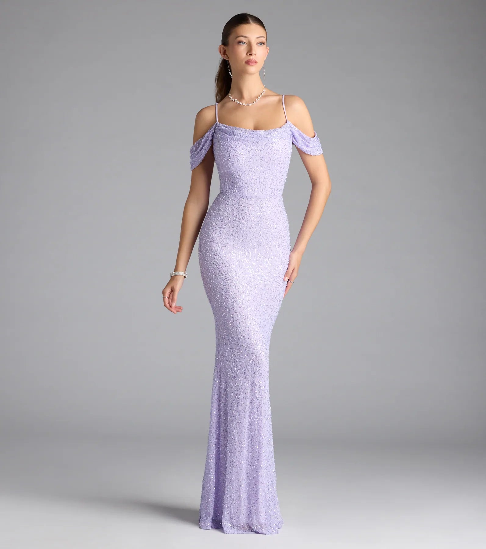 Turn heads at Prom 2025 in this lavender prom dress, where statement-making details meet the iconic style of the Faye Cold Shoulder Mermaid Beaded Formal Dress.