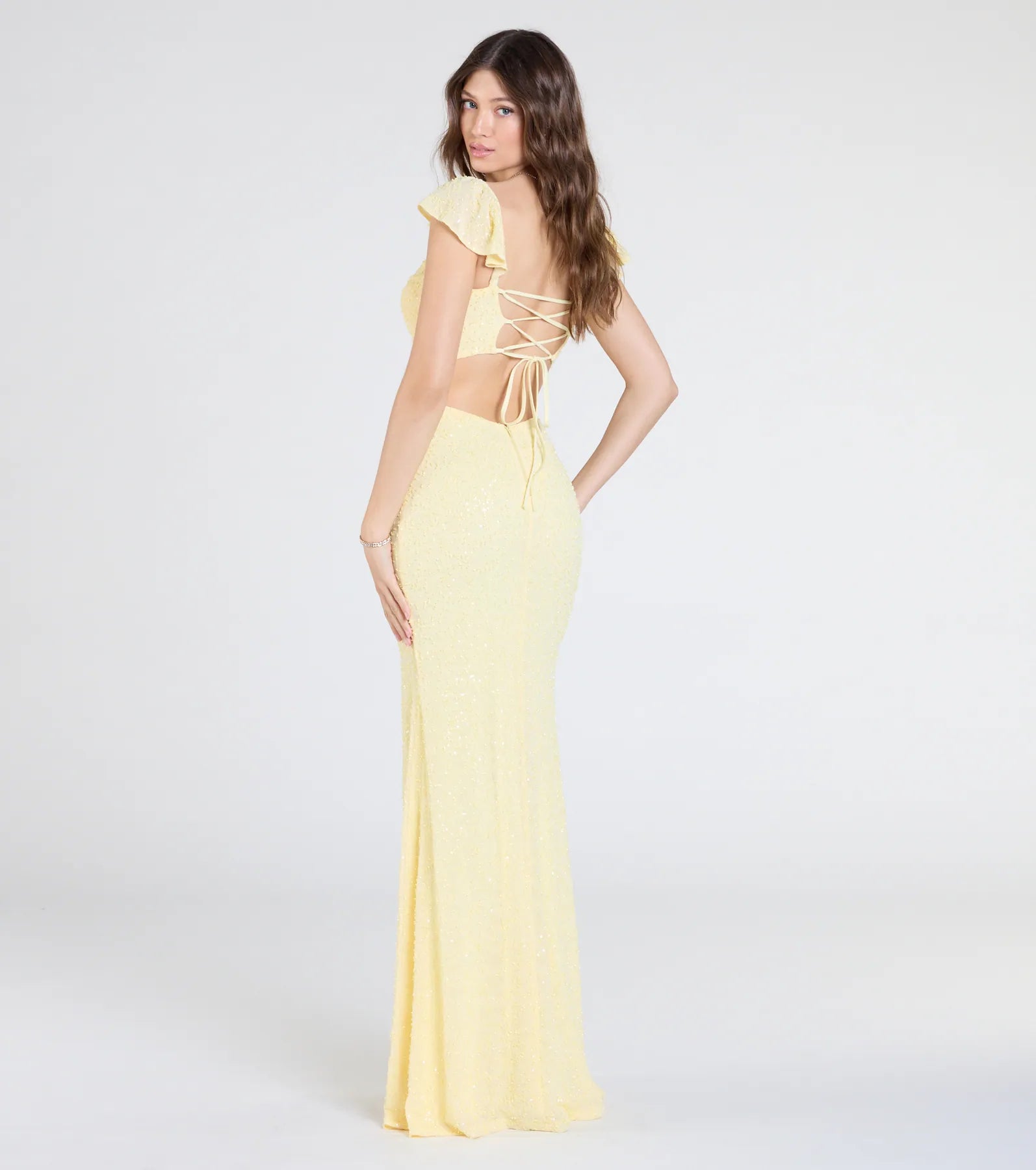 Turn heads at Prom 2025 in this yellow prom dress, where statement-making details meet the iconic style of the Tanya Lace-Up Slit Mermaid Beaded Formal Dress.