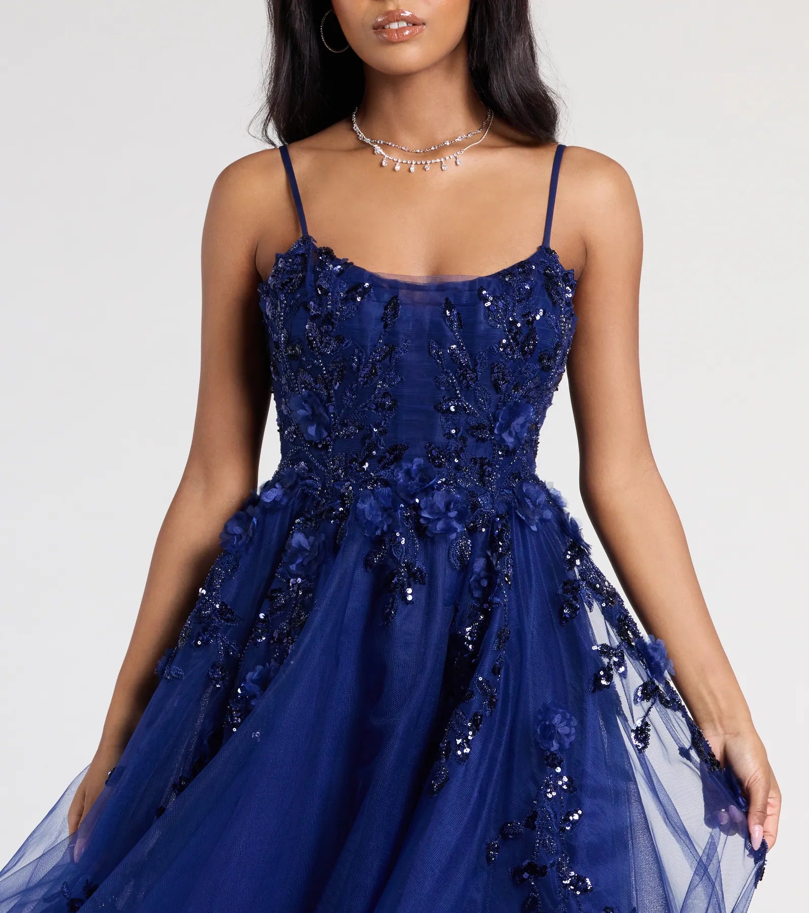 Turn heads at Prom 2025 in this navy blue prom dress, where statement-making details meet the iconic style of the Lula A-Line Sequin Floral Tulle Ball Gown.