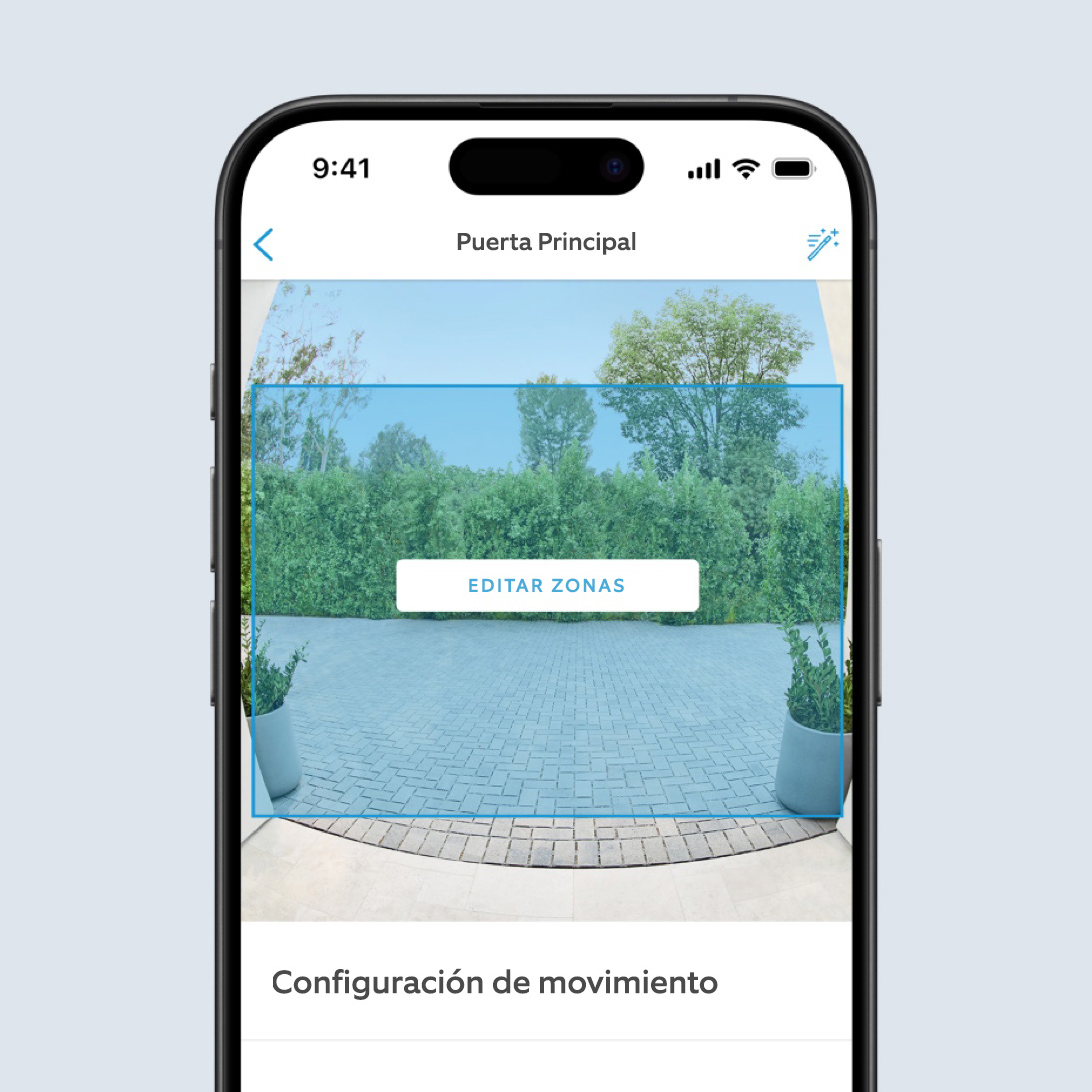 La pantalla de un teléfono muestra un video en la app de Ring de una entrada. Un cuadro azul cubre la mayor parte de la imagen. El texto dice: “Editar zonas”.