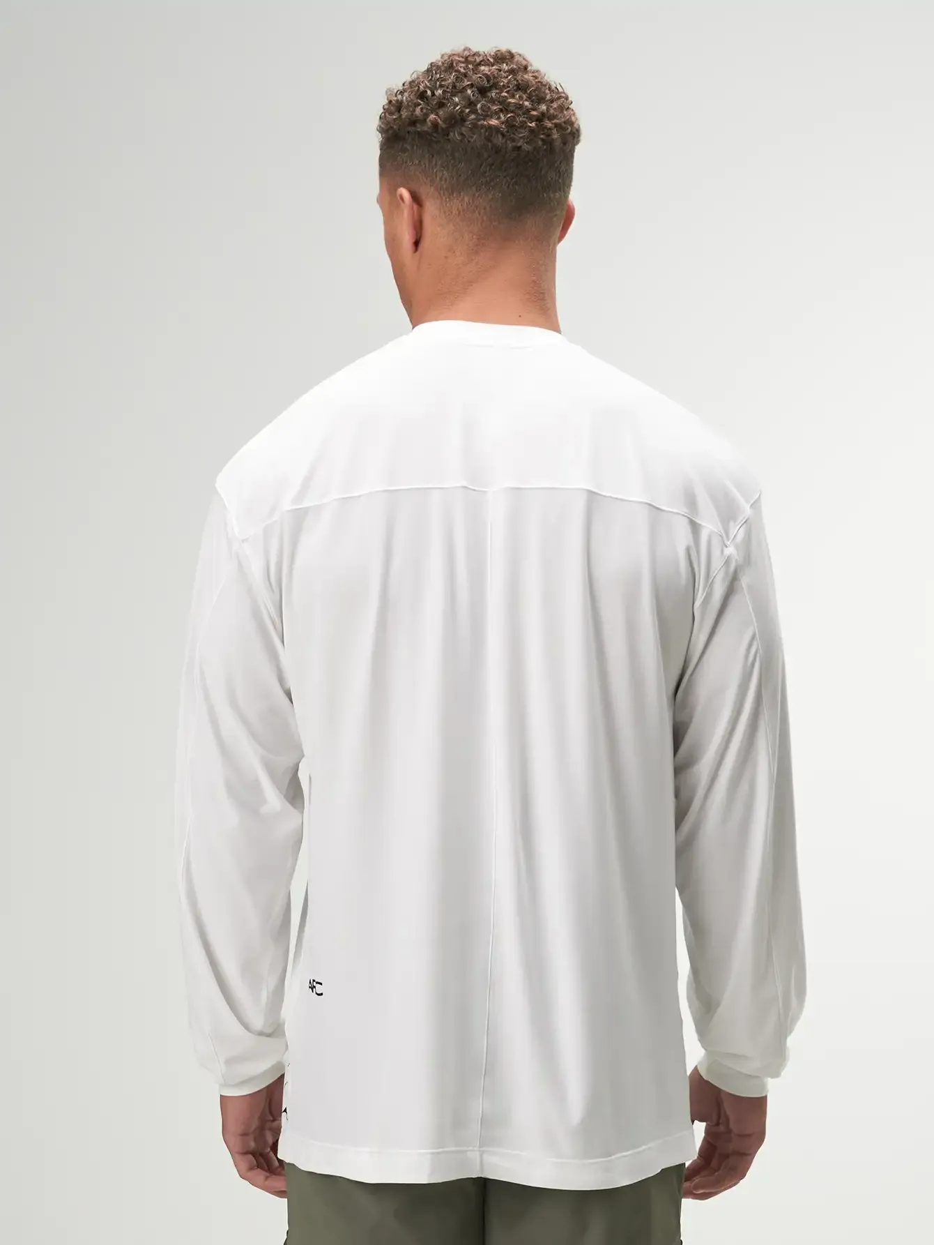 Oversized white long sleeve performance shirt for gym workouts by ARC Activewear, perfect for active lifestyles.
