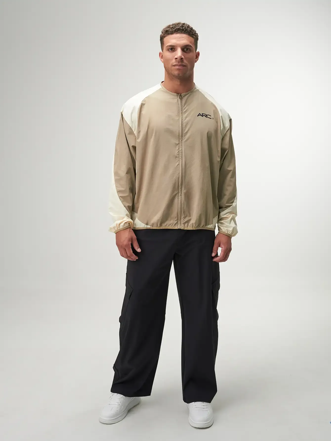 Statement Full Zip Jacket in black, featuring a modern design, lightweight fabric, and stylish zippered pockets.