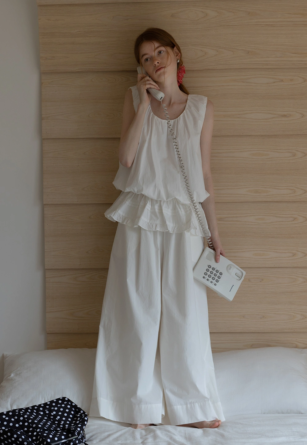 Sleeveless layered top and wide-leg pants
