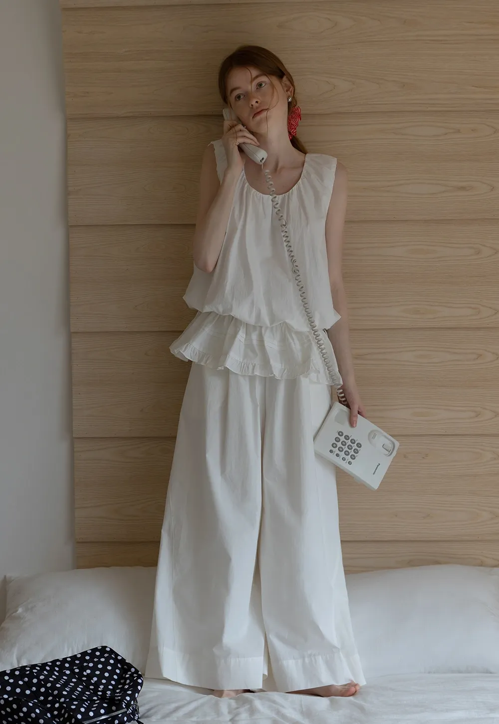 Sleeveless layered top and wide-leg pants