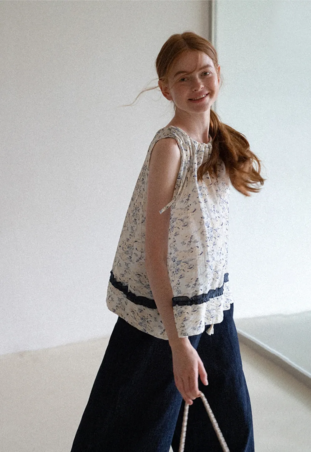 Floral Sleeveless Blouse with Ruffle Hem