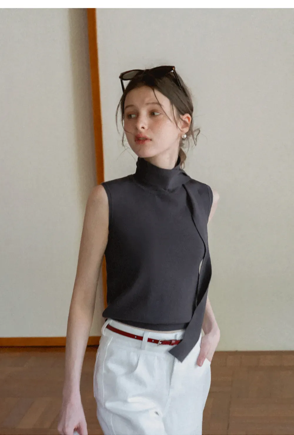 Sleeveless high neck knit top with side tie detail