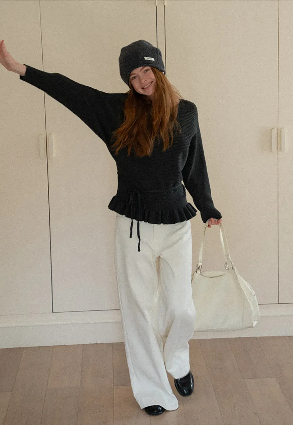 Ribbed knit sweater with tie back and flared hem design