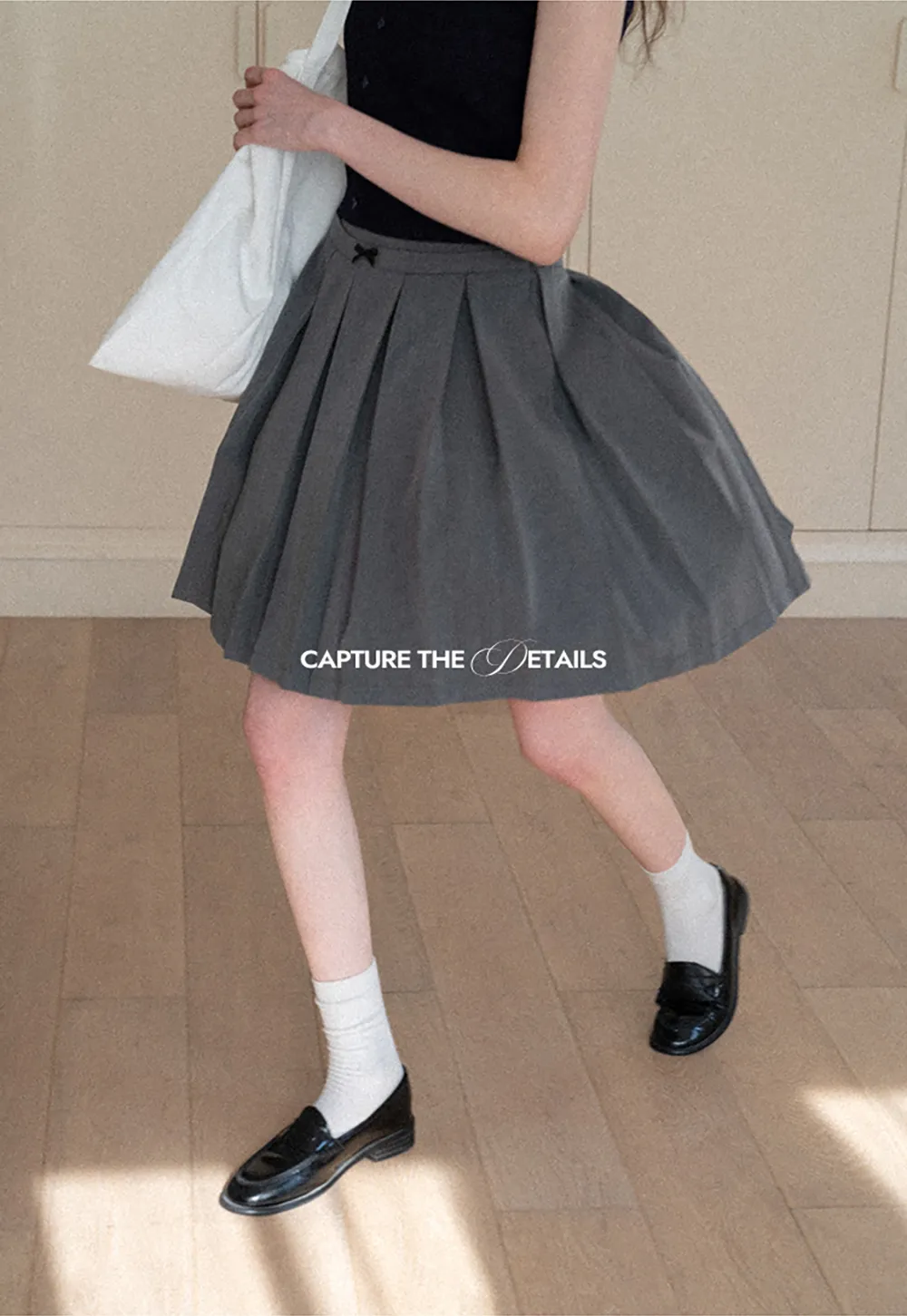 Pleated skirt with front bow detail