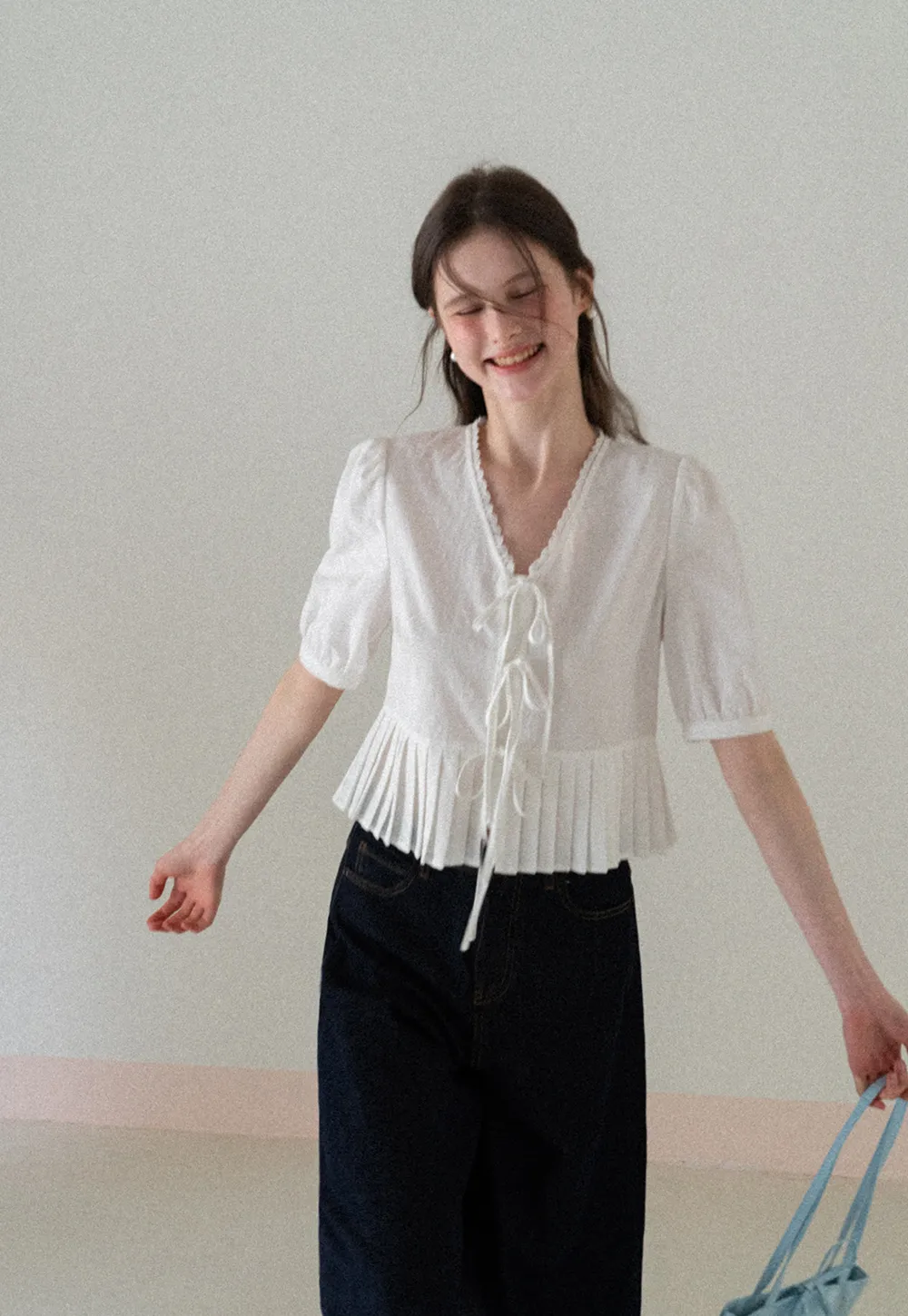 V neck short sleeve blouse with pleated hem and tie front