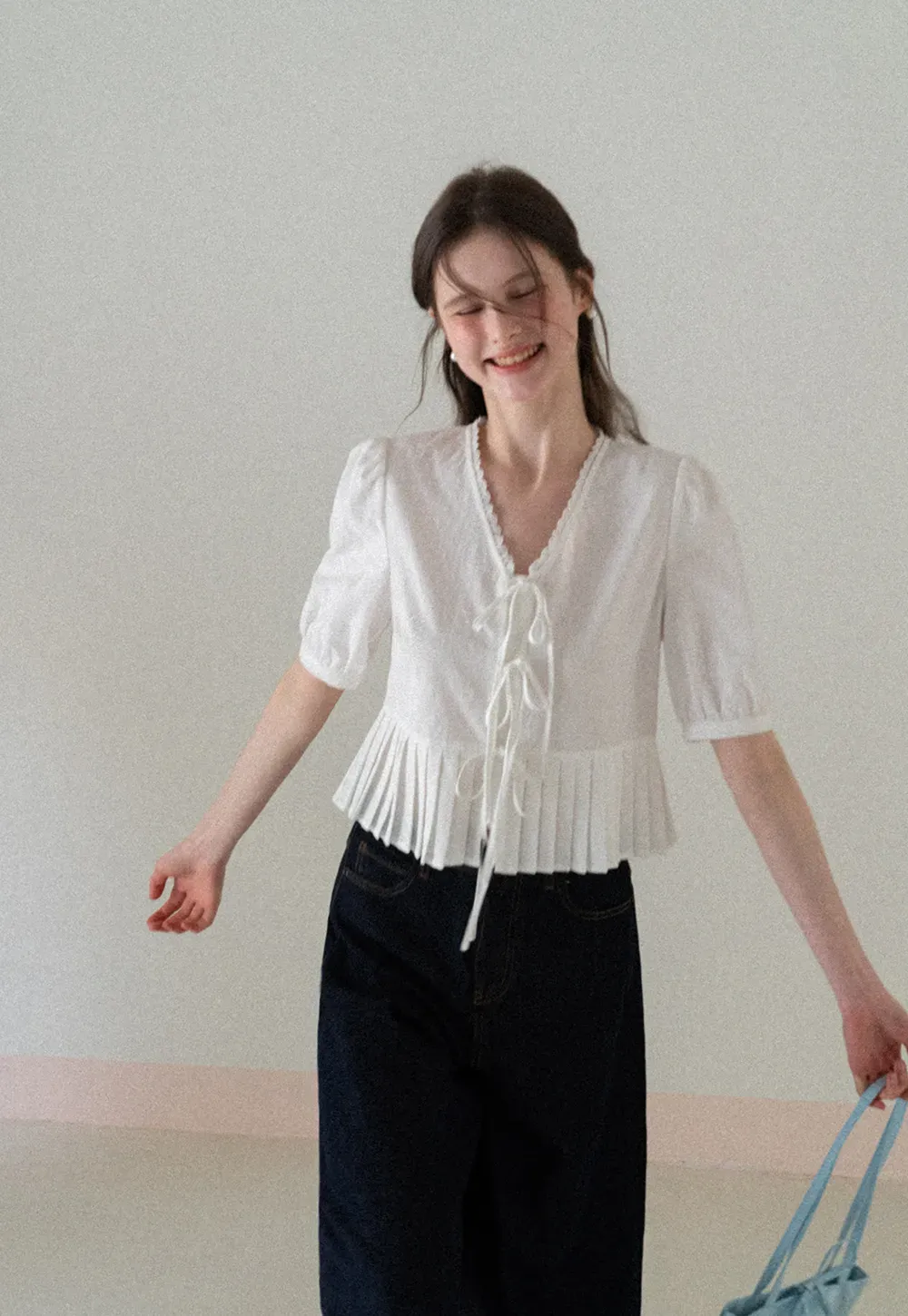 V neck short sleeve blouse with pleated hem and tie front