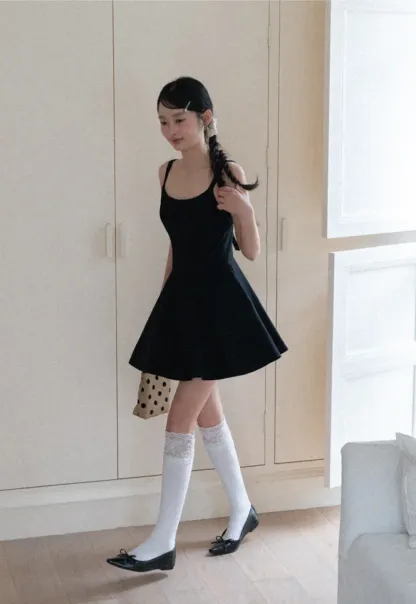 Sleeveless dress with thin straps and flared skirt