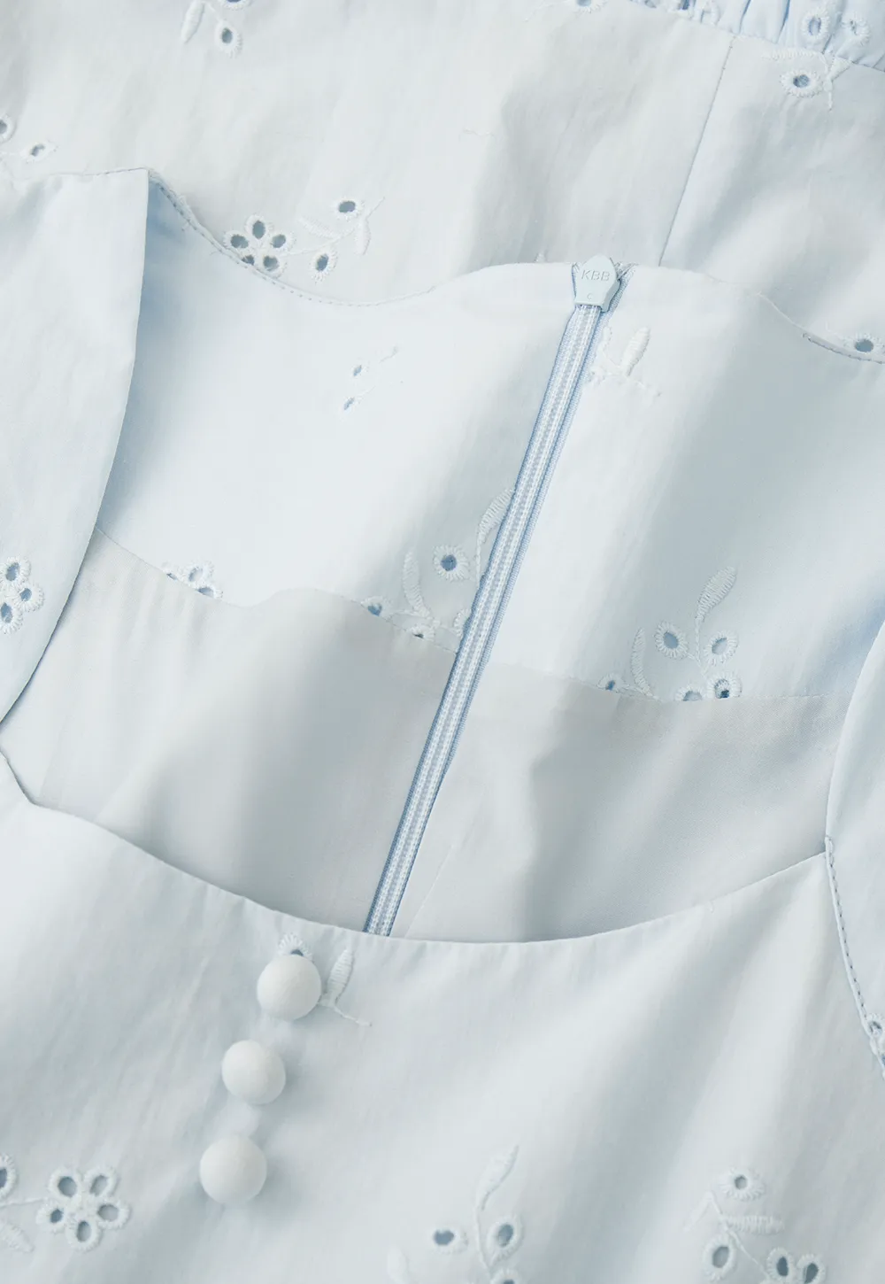 Eyelet dress with puff sleeves and ruffled hem