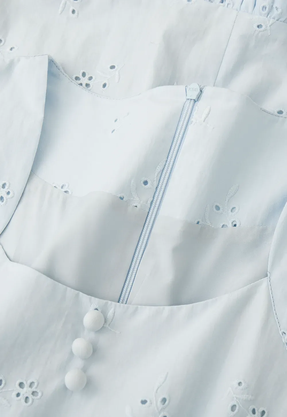 Eyelet dress with puff sleeves and ruffled hem