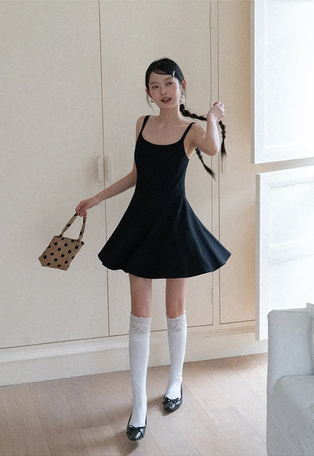 Sleeveless dress with thin straps and flared skirt