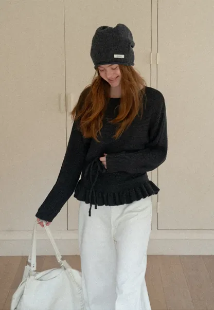 Ribbed knit sweater with tie back and flared hem design
