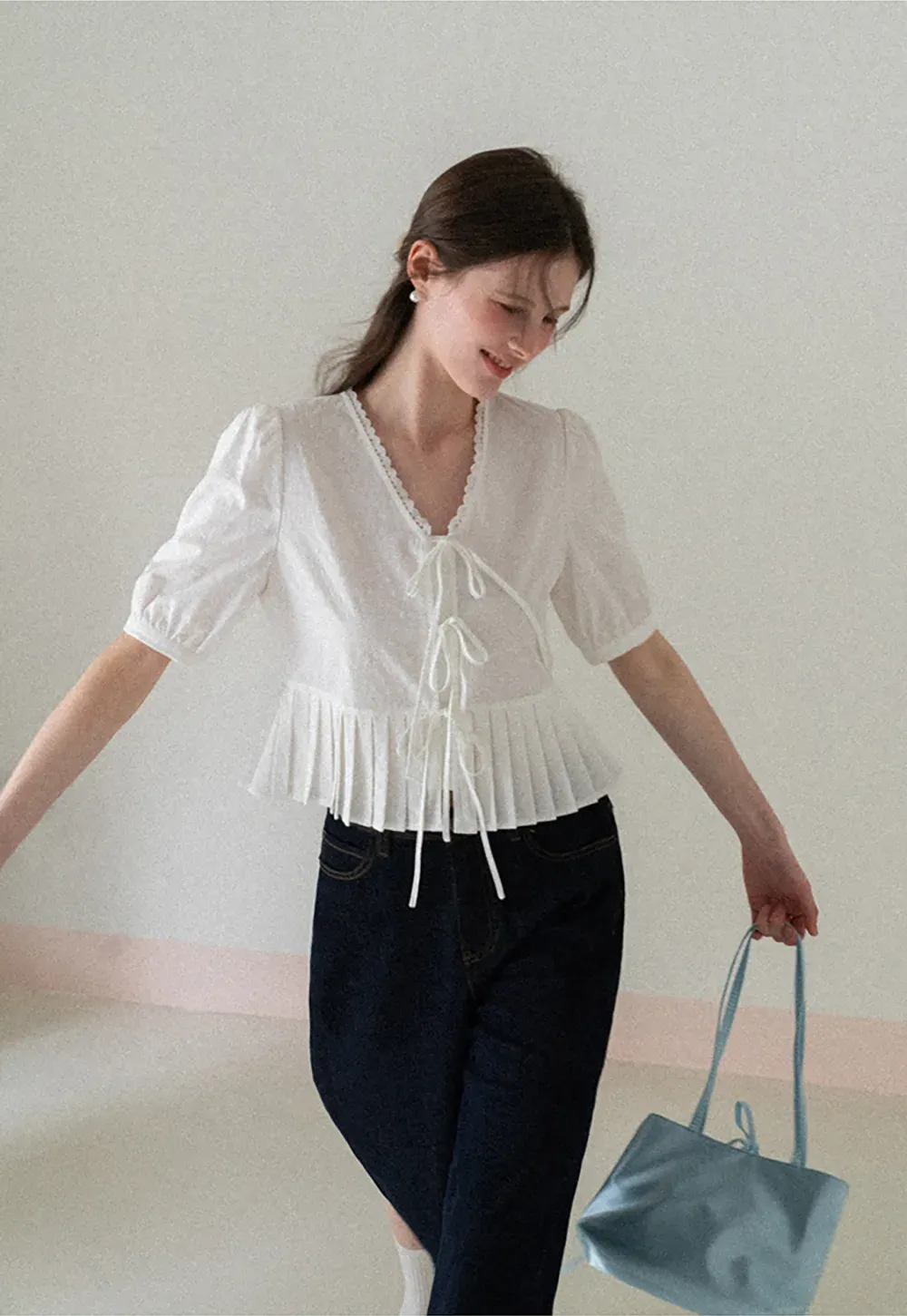V neck short sleeve blouse with pleated hem and tie front