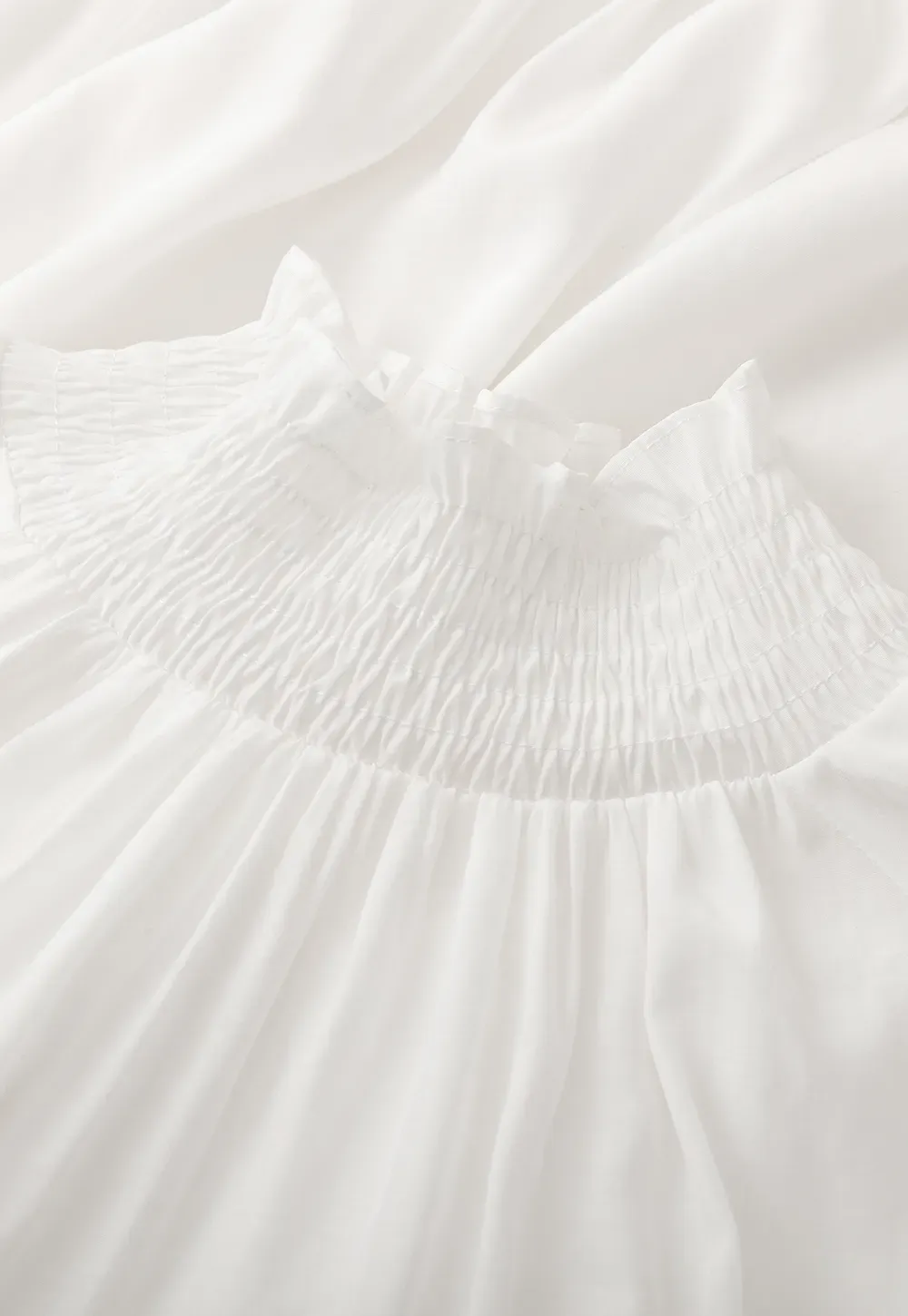 Elegant High Neck Blouse with Ruffled Cuffs and Hem