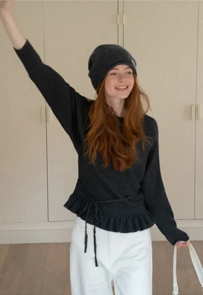 Ribbed knit sweater with tie back and flared hem design