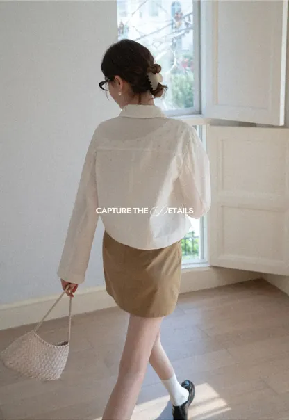 Short jacket with ruffled front placket and collar